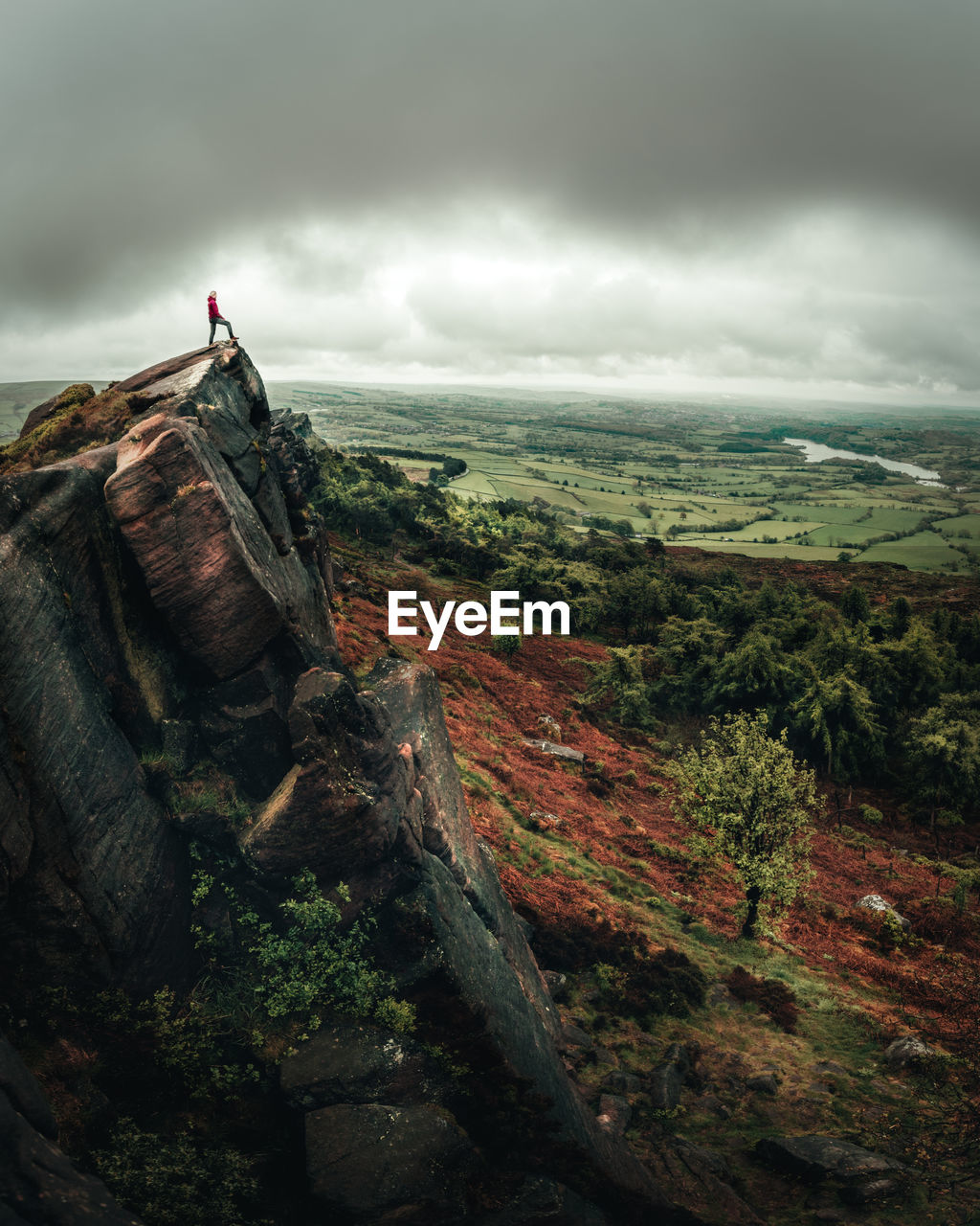 Rear view of woman standing on mountain against sky