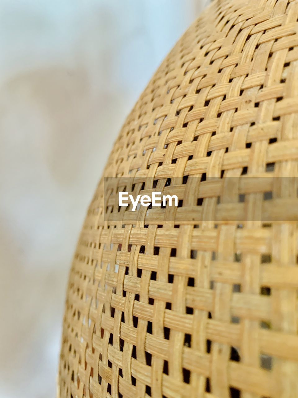 CLOSE-UP OF WICKER BASKET ON WOOD
