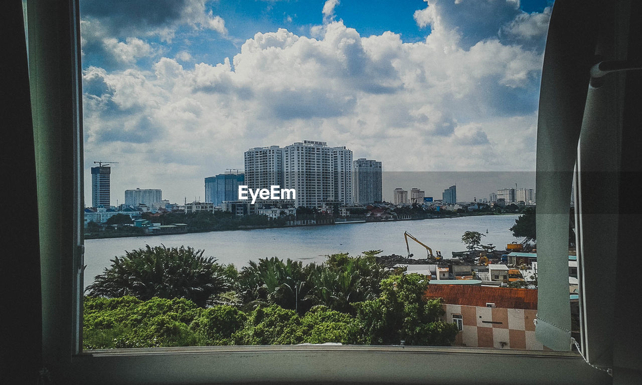 VIEW OF CITY AGAINST CLOUDY SKY