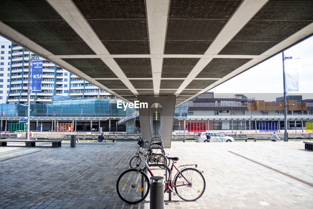 Bicycles parked under bridge