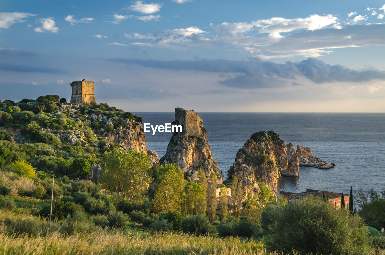 PANORAMIC VIEW OF SEA AND ROCKS AGAINST SKY