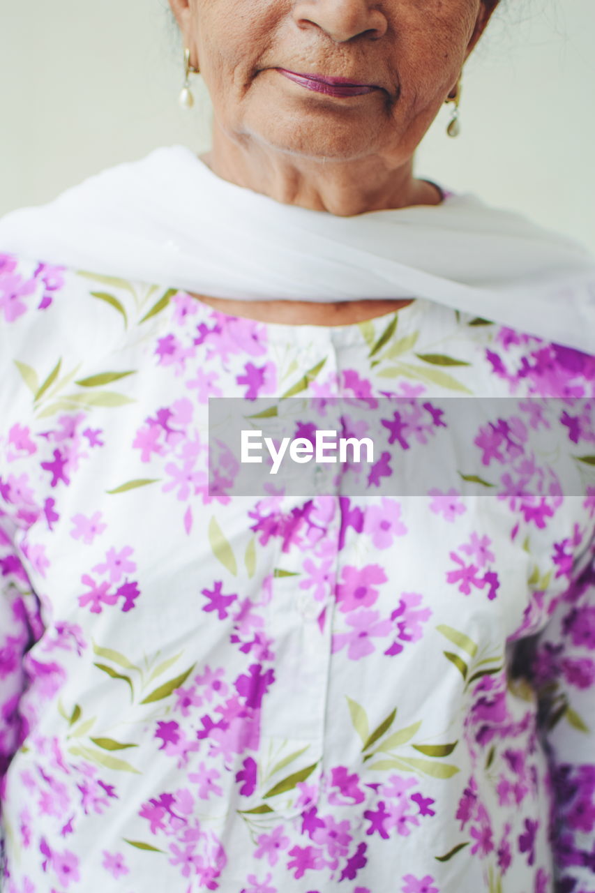 Midsection of senior woman wearing floral indian dress