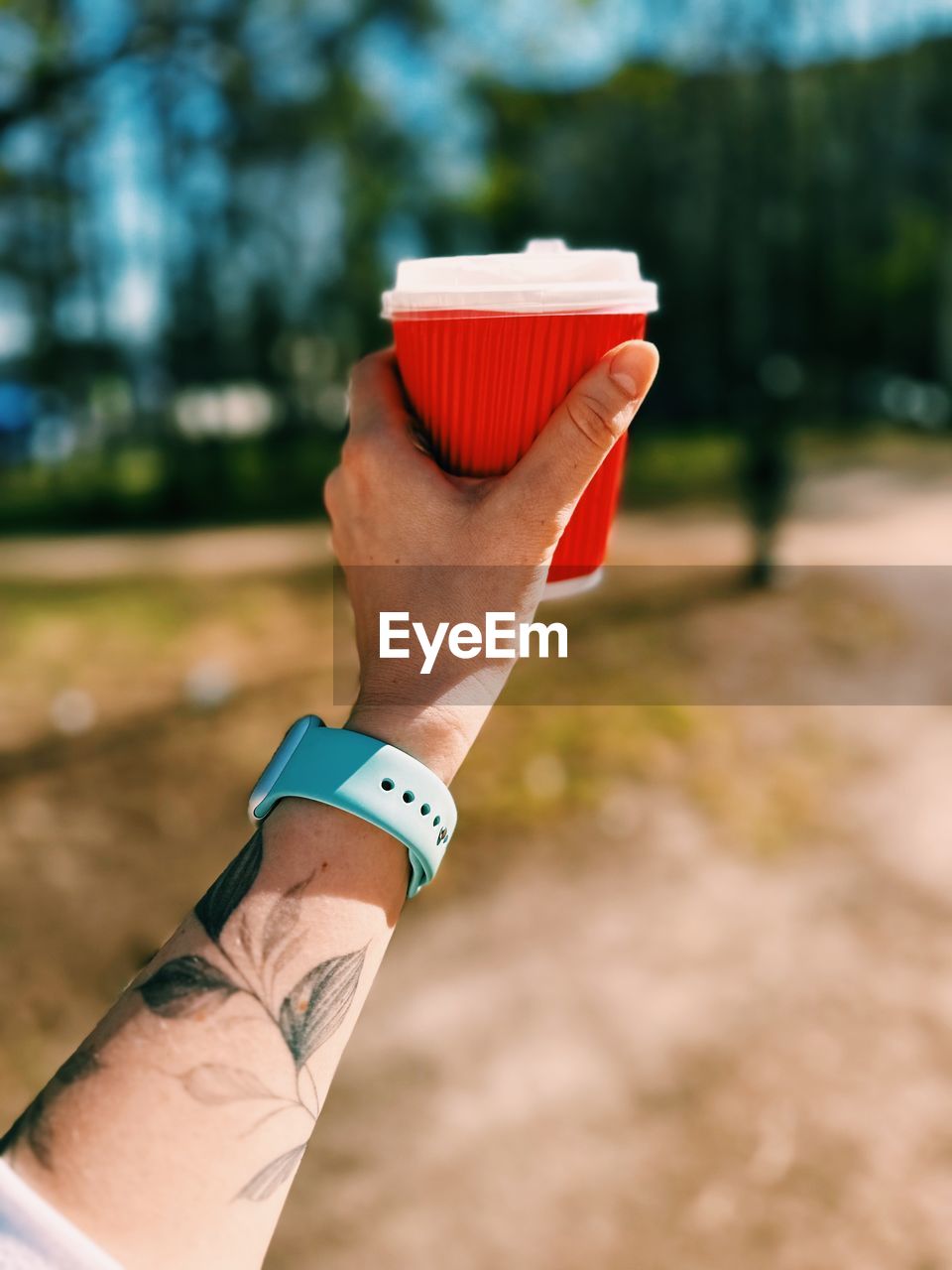 Cropped hand of woman holding coffee