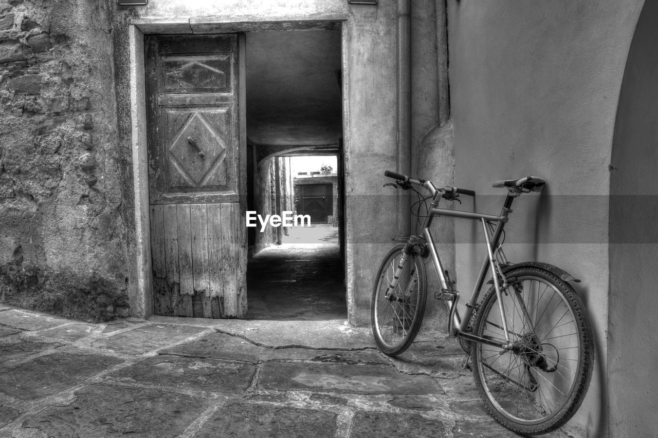 BICYCLE PARKED OUTSIDE HOUSE