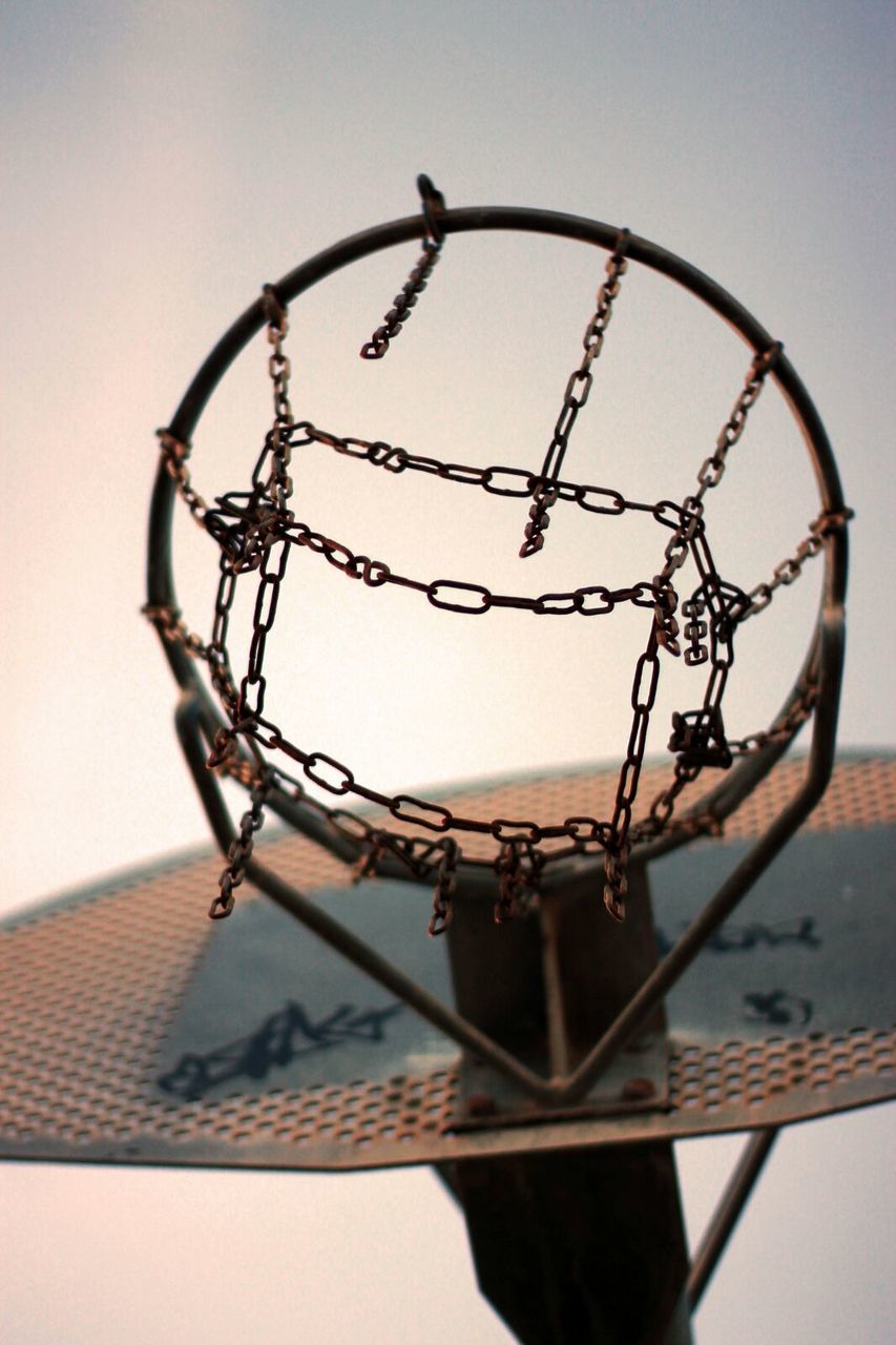LOW ANGLE VIEW OF BASKETBALL HOOP AGAINST CLEAR SKY