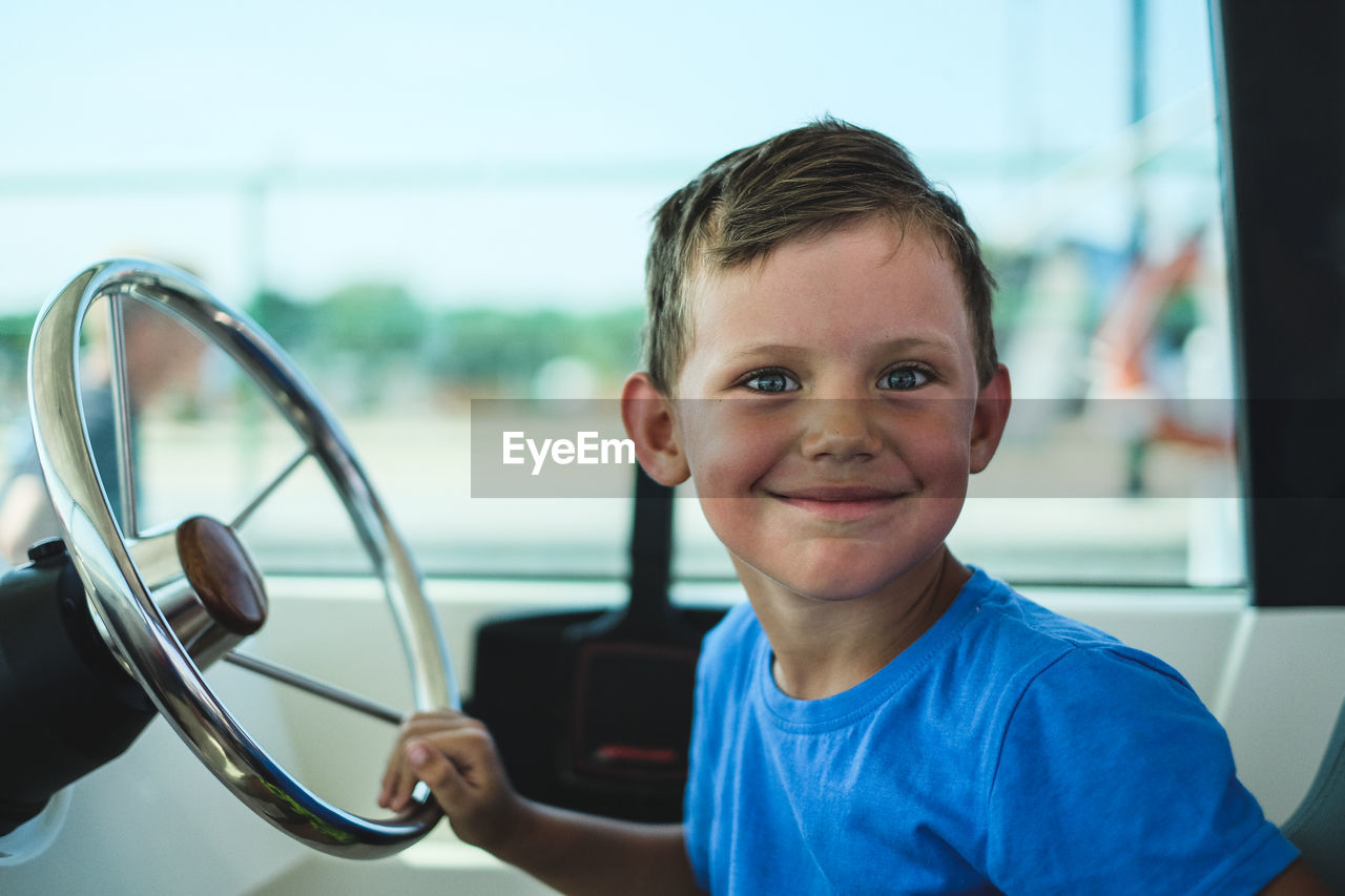 Portrait of boy sitting in car