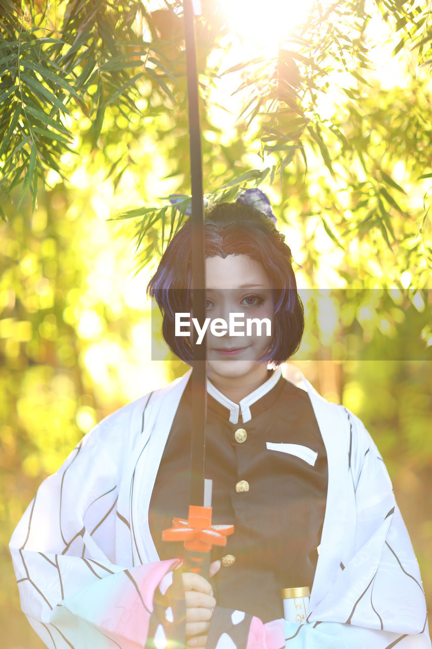 portrait of woman standing against plants