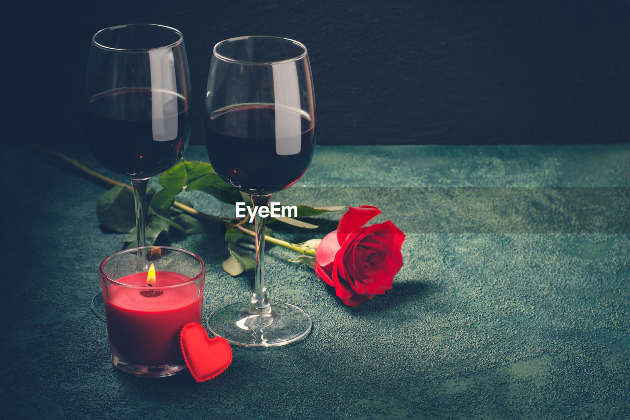 Valentines day greeting card concept. wine glasses, rose and candle