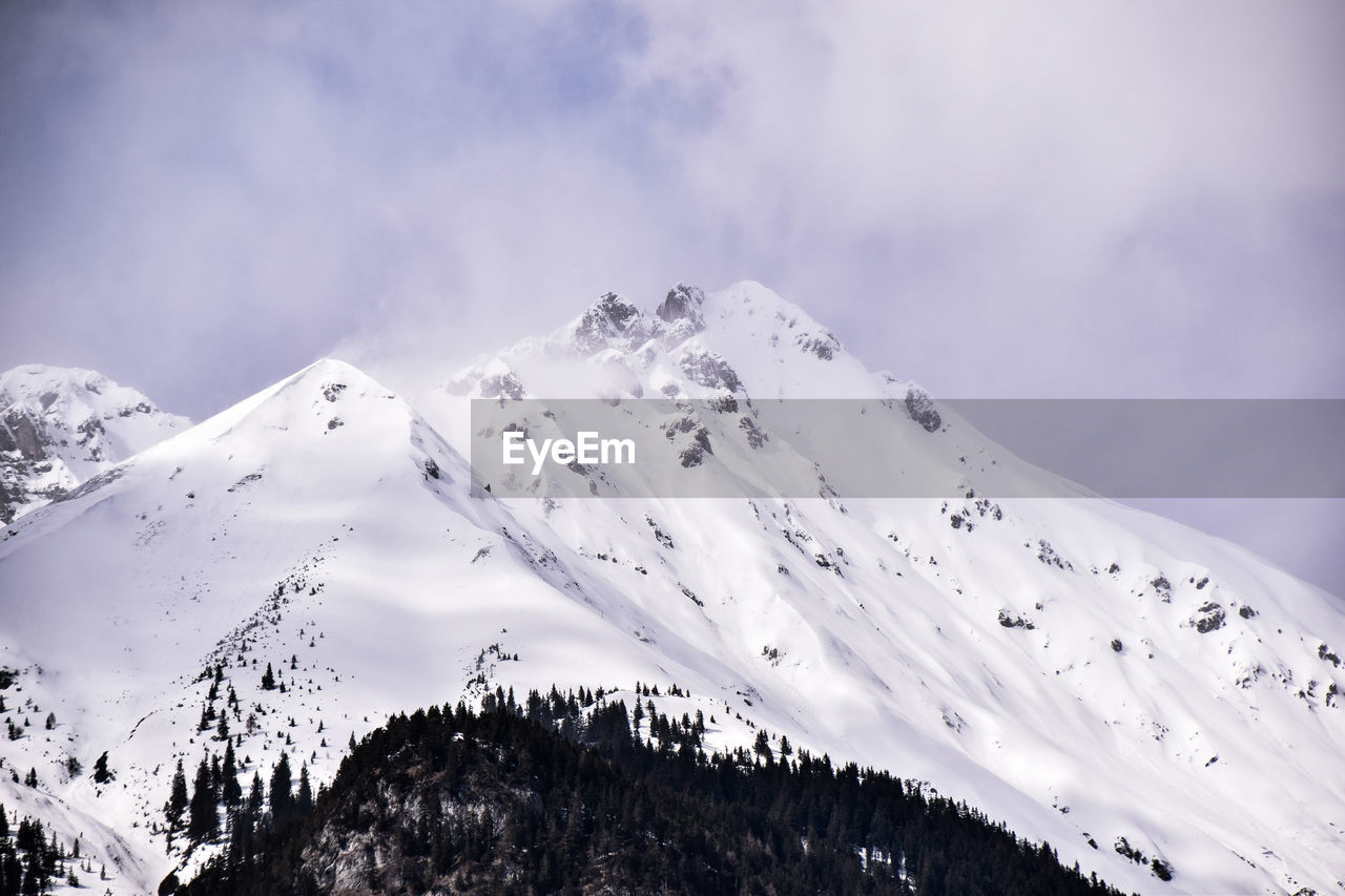 Scenic view of snow covered mountains against sky