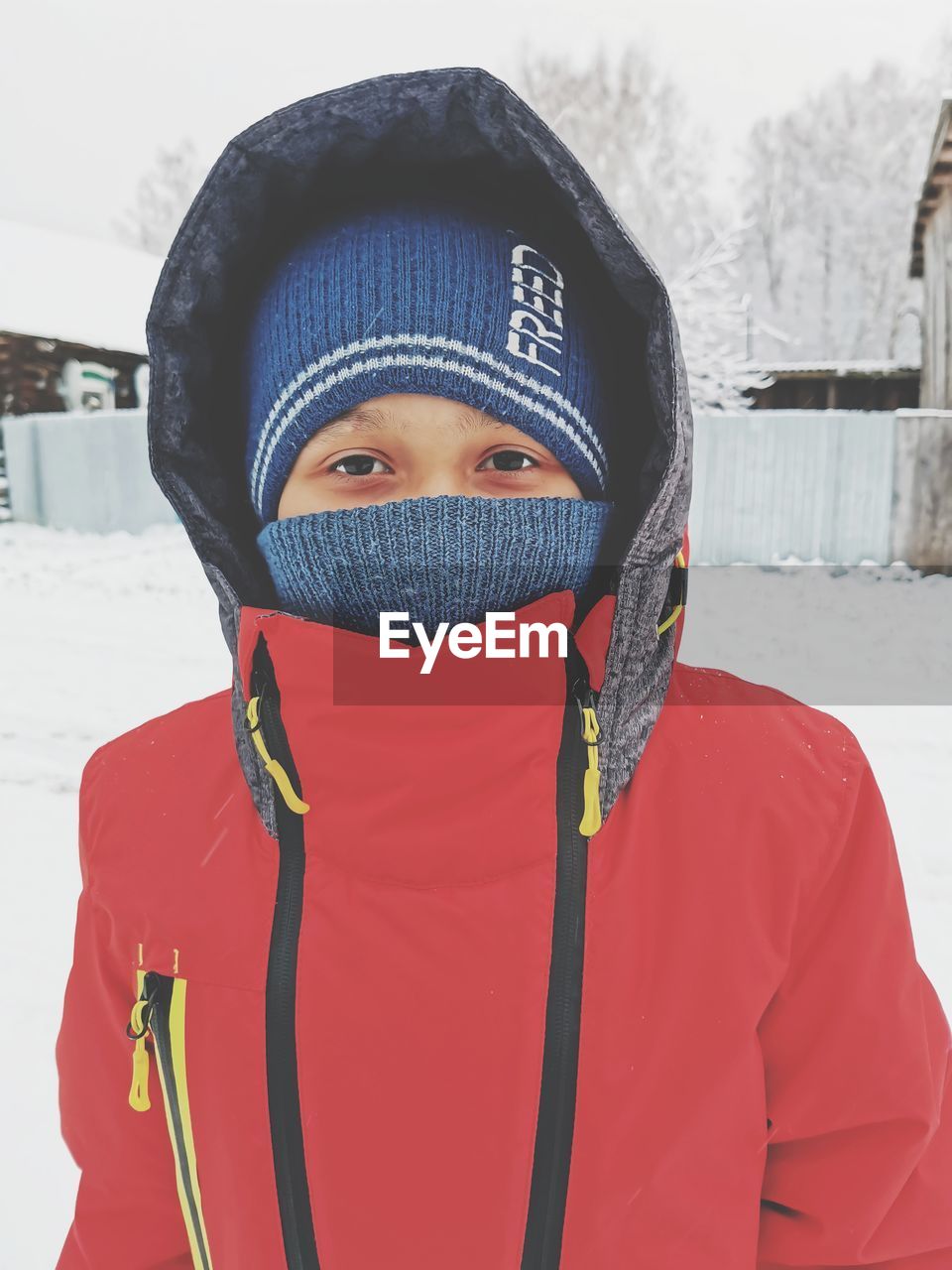 Portrait of young woman covered with snow during winter