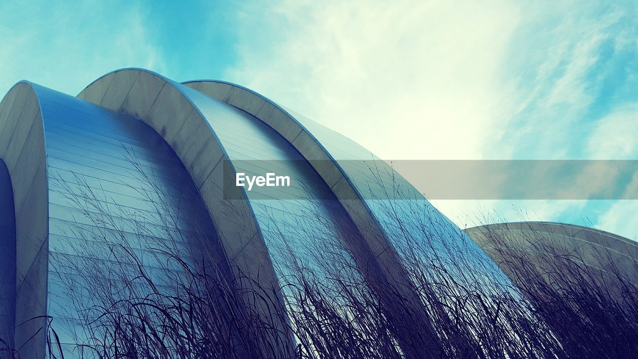 LOW ANGLE VIEW OF BUILT STRUCTURES AGAINST BLUE SKY