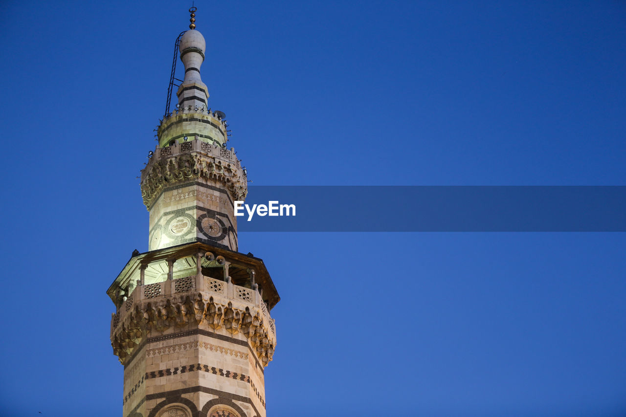 Low angle view of tower against clear blue sky