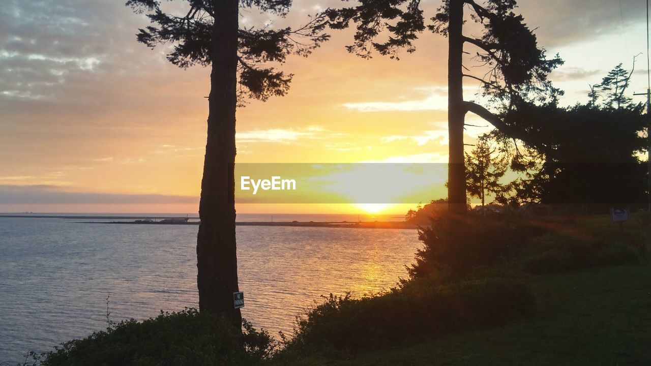 Scenic view of lake against sky during sunrise