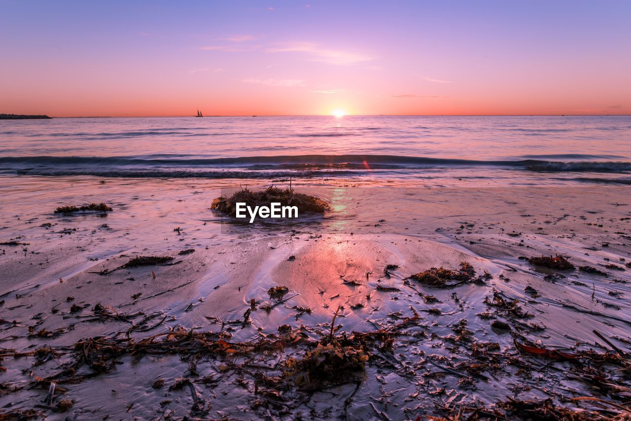 Scenic view of sea against sky at sunset