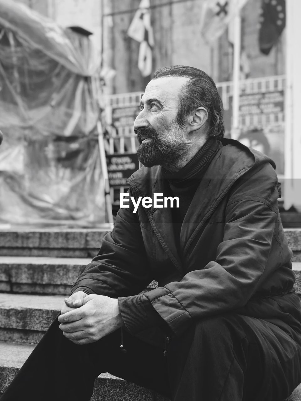 Man sitting on staircase in city