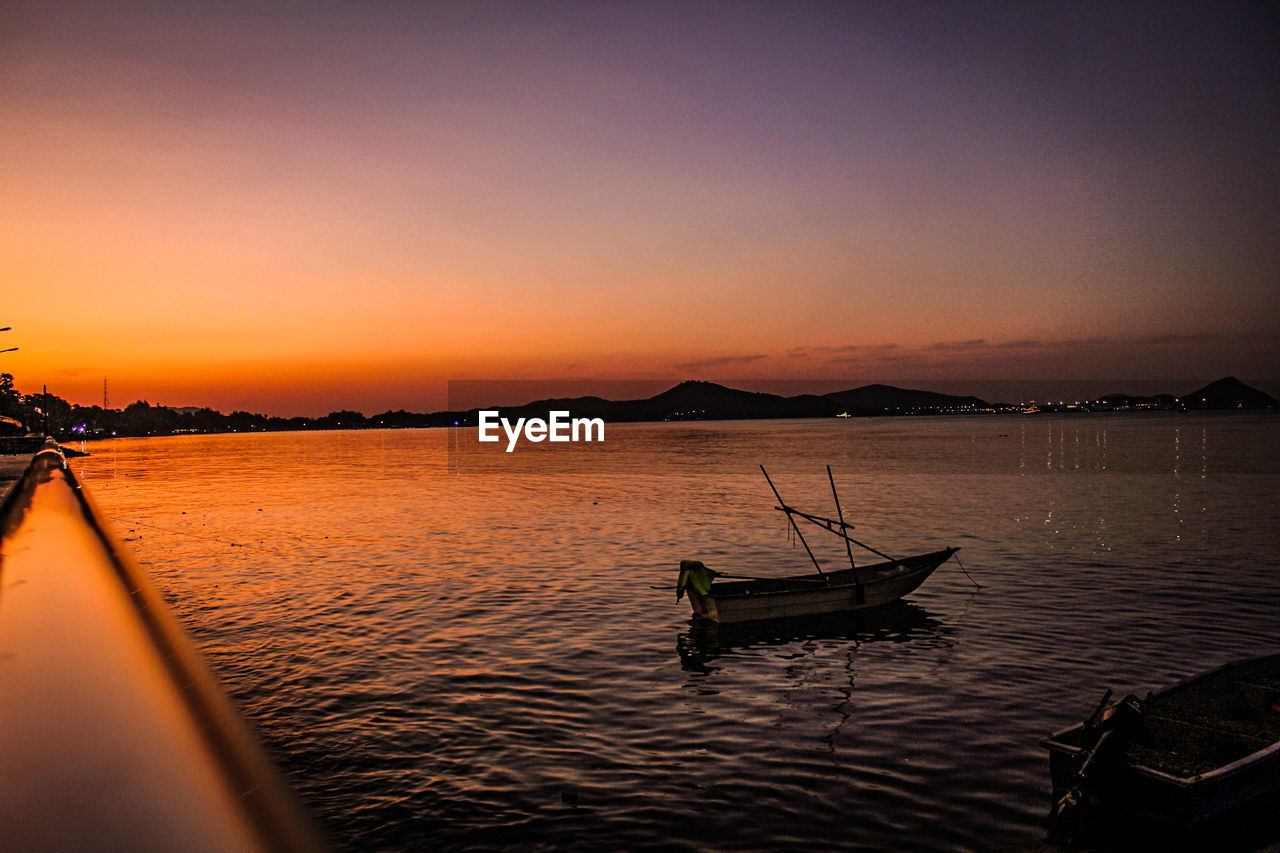 Scenic view of lake against sky during sunset