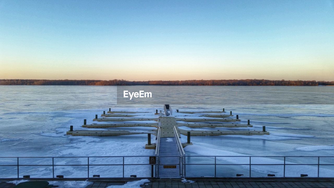 View of frozen sea against clear blue sky