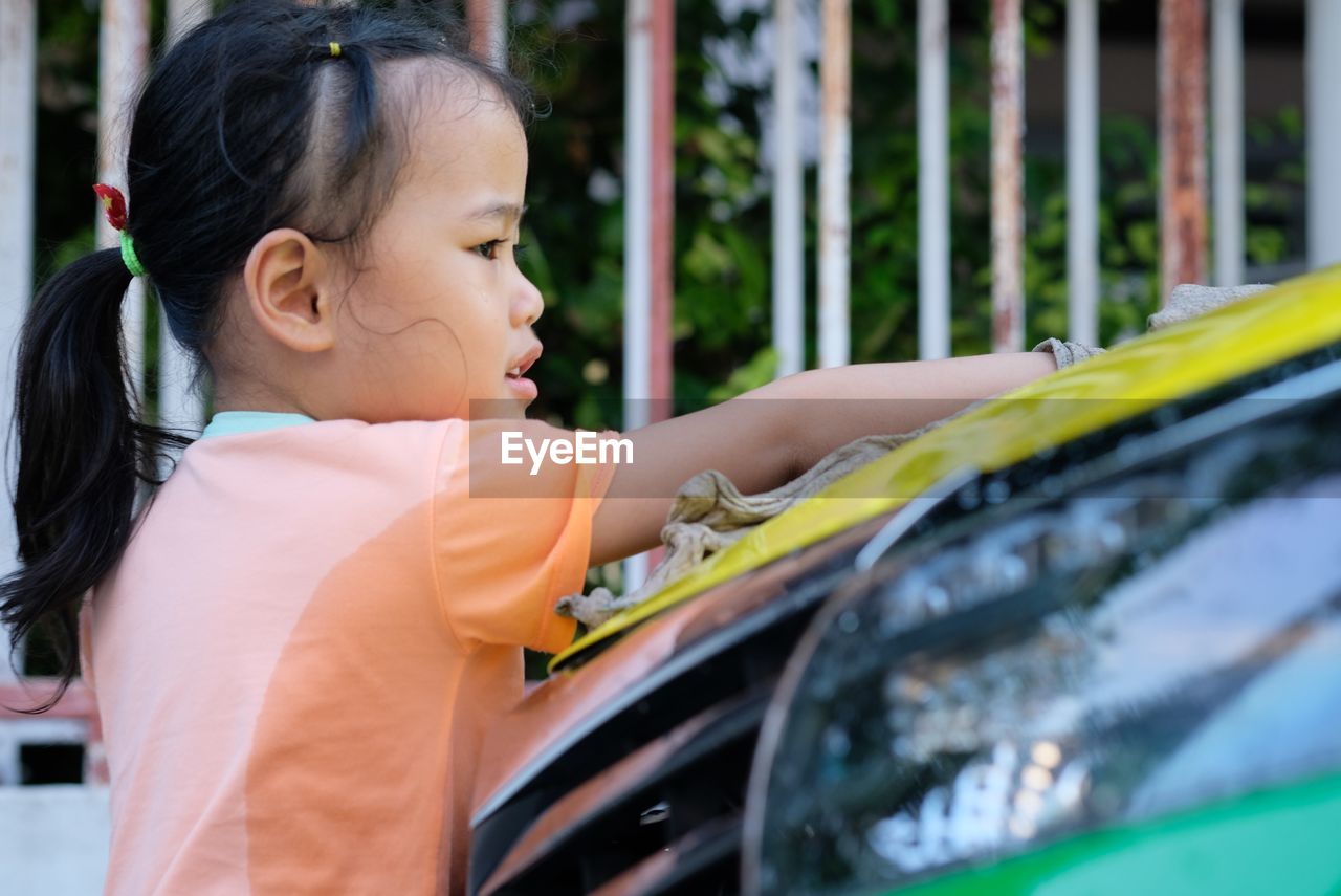 Girl cleaning car