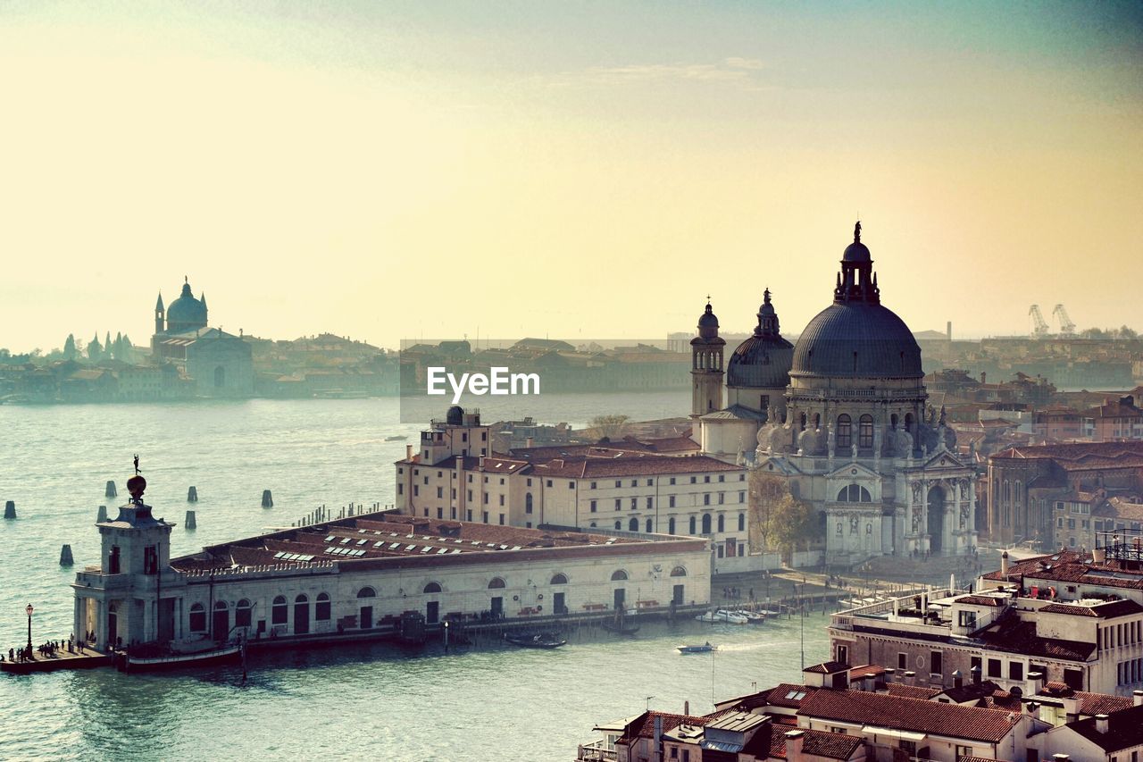 Santa maria della salute and grand canal against sky in city