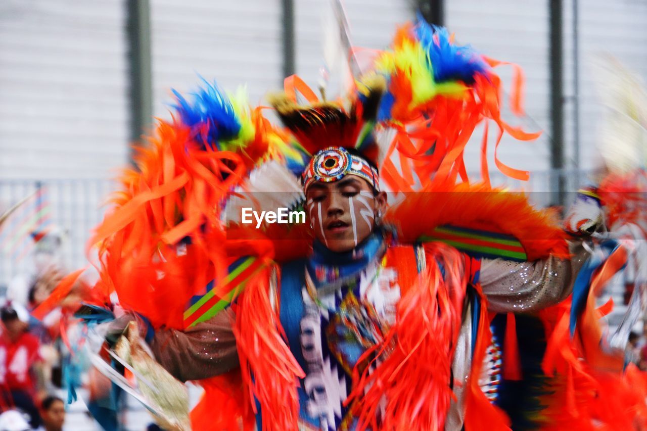 FULL LENGTH PORTRAIT OF MAN WEARING MULTI COLORED TRADITIONAL CLOTHING