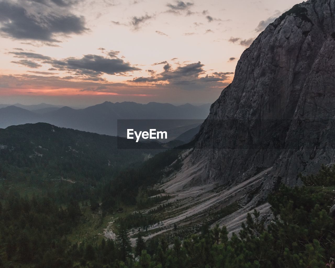 Scenic view of mountains against sky at sunset