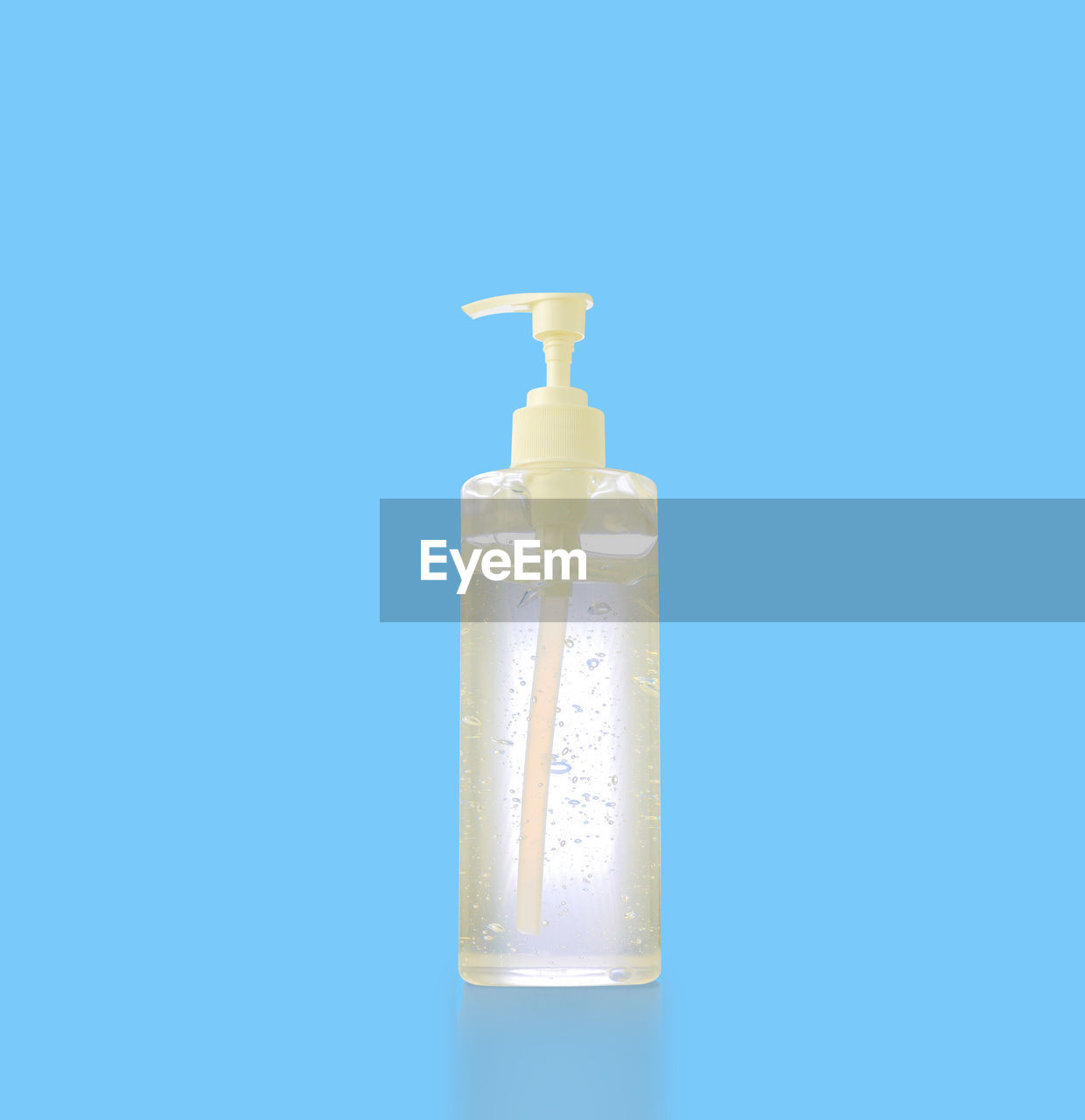 CLOSE-UP OF BOTTLE AGAINST BLUE SKY