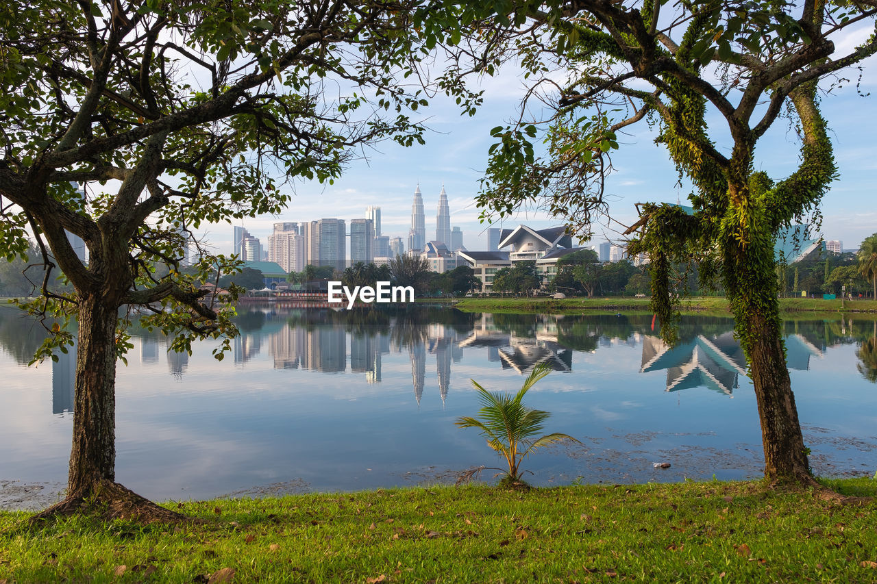 Reflection of trees and buildings in lake