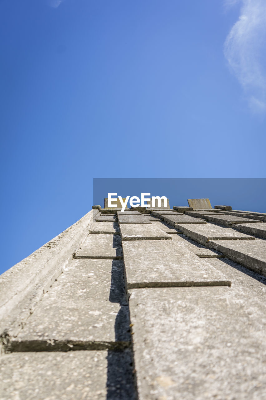 Low angle view of building against clear blue sky