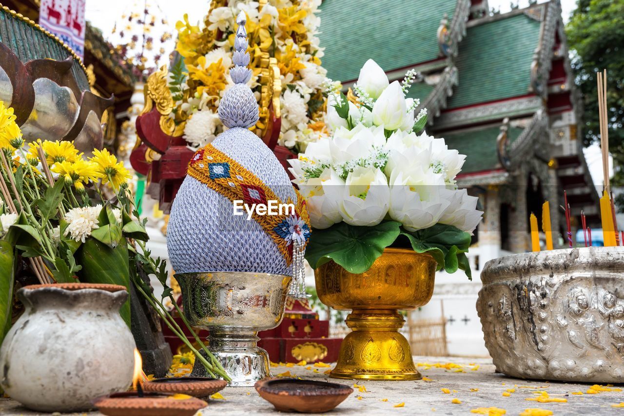 Close-up of floral offerings at a temple in chiang rai thailand