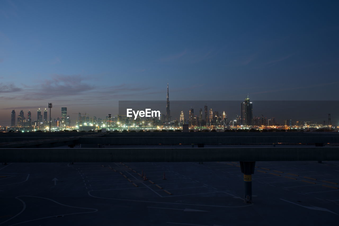 Dubai skyline at night from meydan district, dubai downtown and business bay area