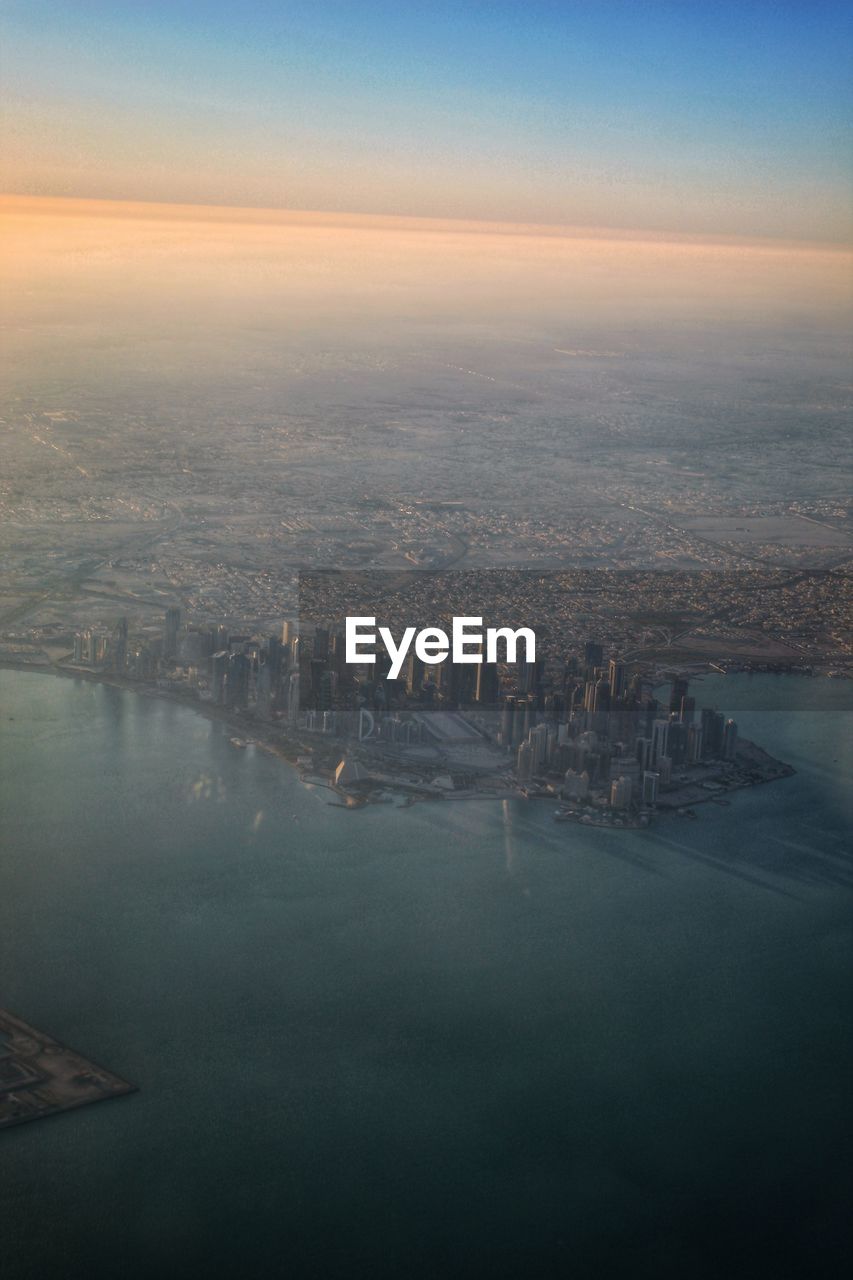AERIAL VIEW OF BUILDINGS IN CITY DURING SUNSET