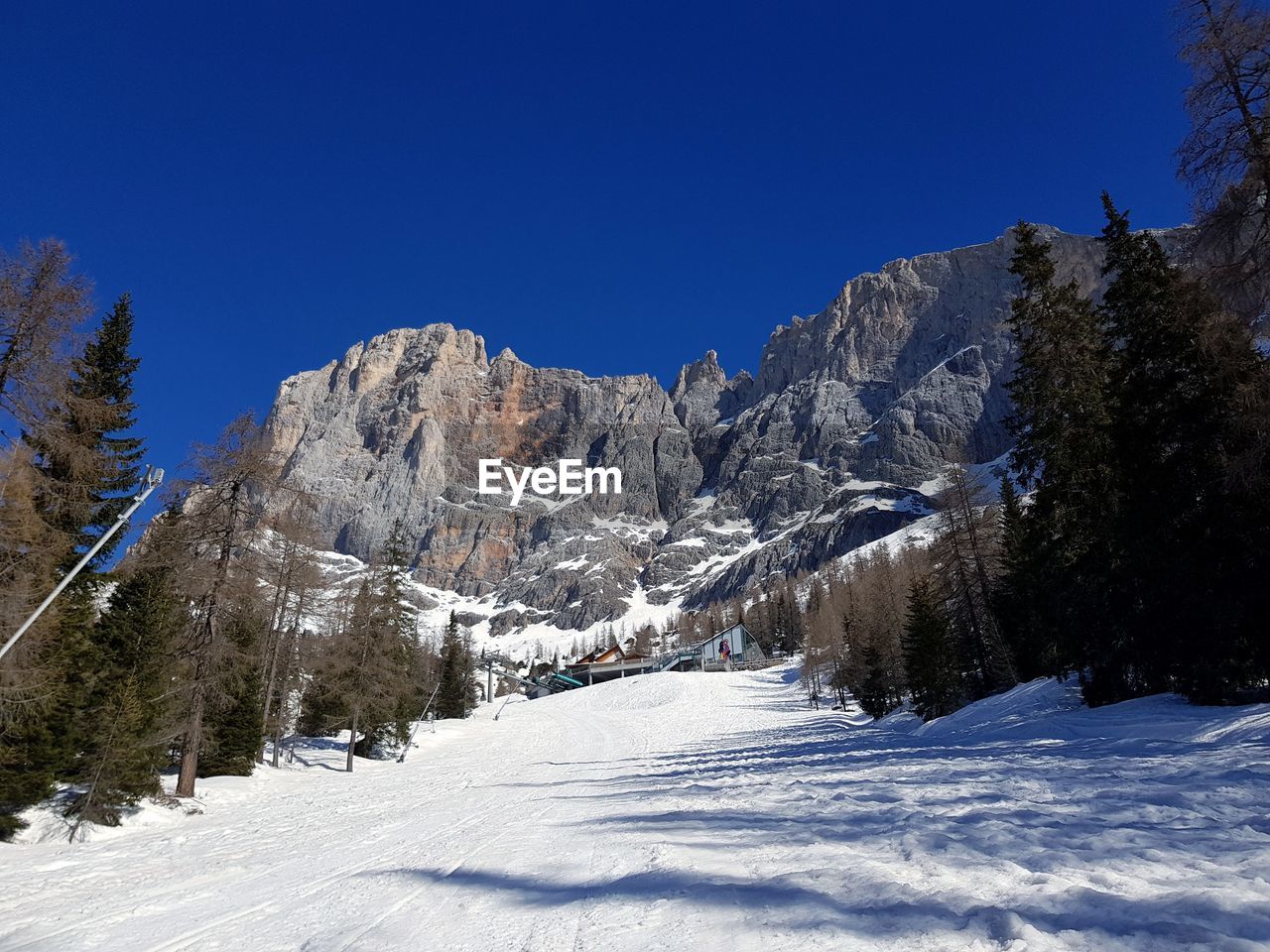 Scenic view of snowcapped mountains against clear blue sky