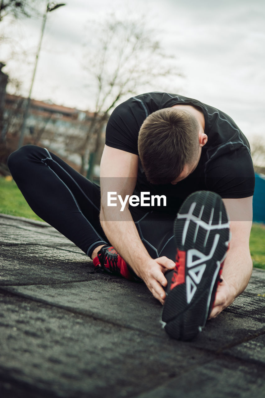 Young man exercising at public park