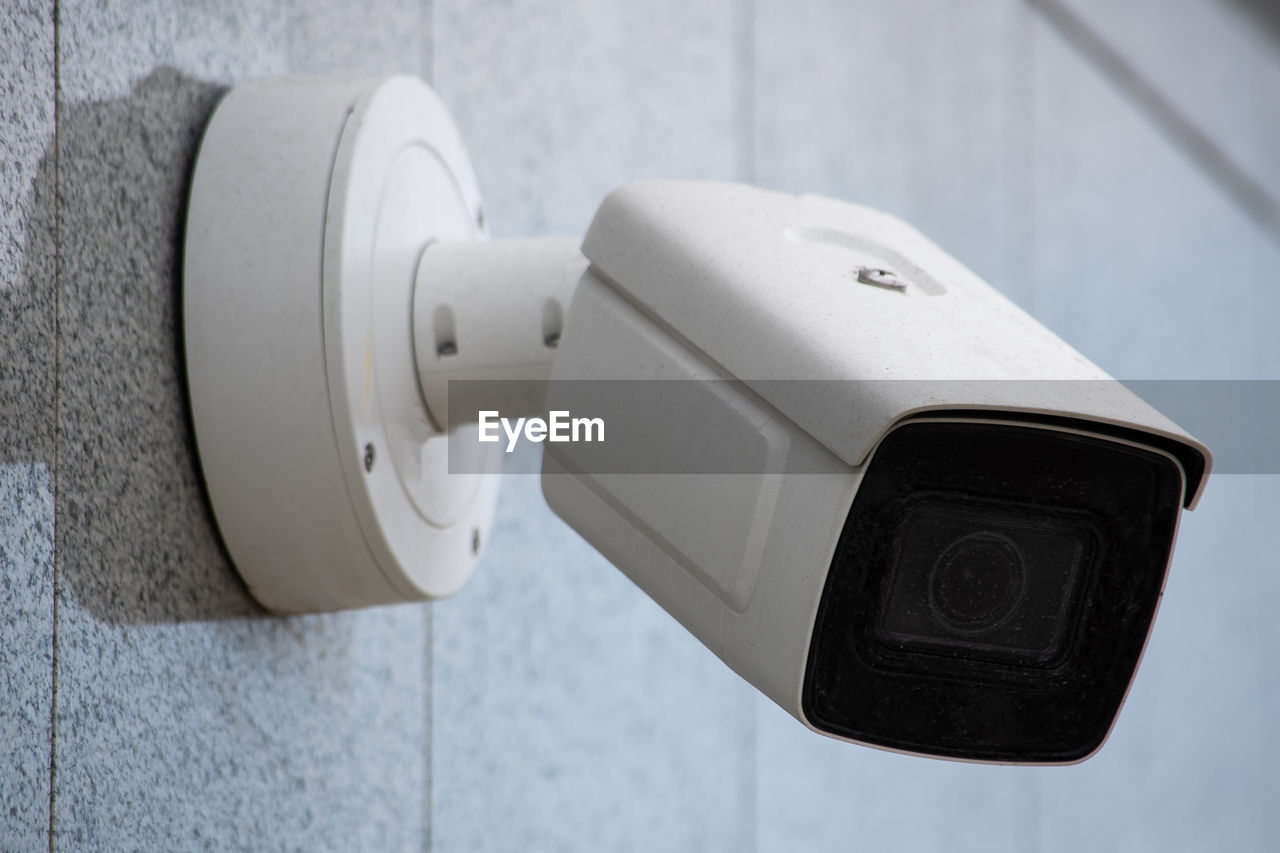 Surveillance camera on wall, outdoors. video observation at modern house