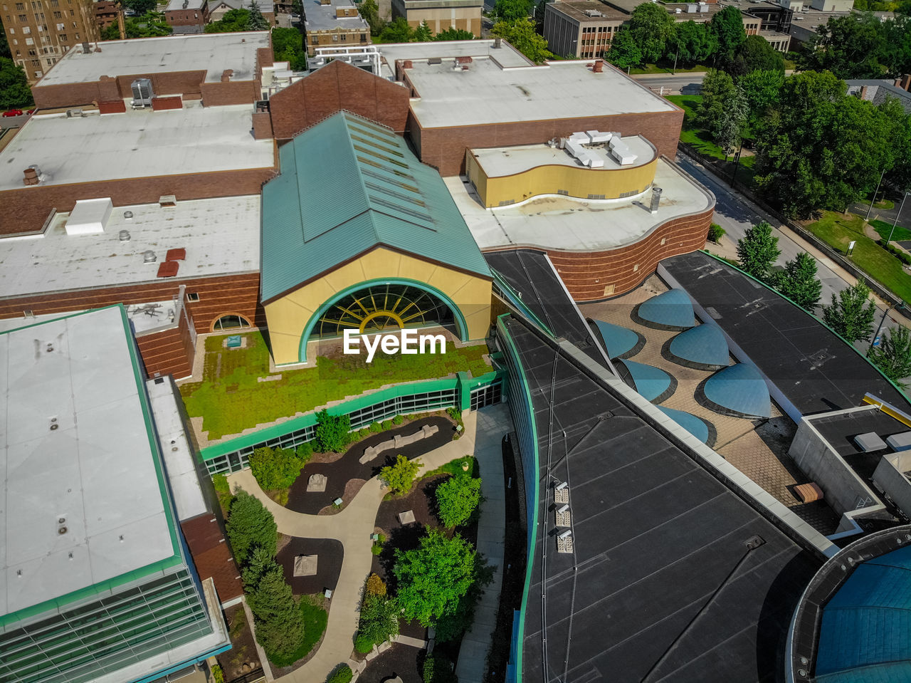 HIGH ANGLE VIEW OF SWIMMING POOL AGAINST BUILDINGS