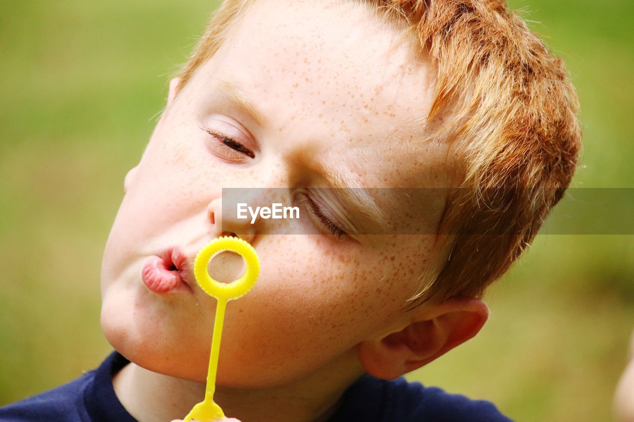 Close-up of boy holding bubble wand