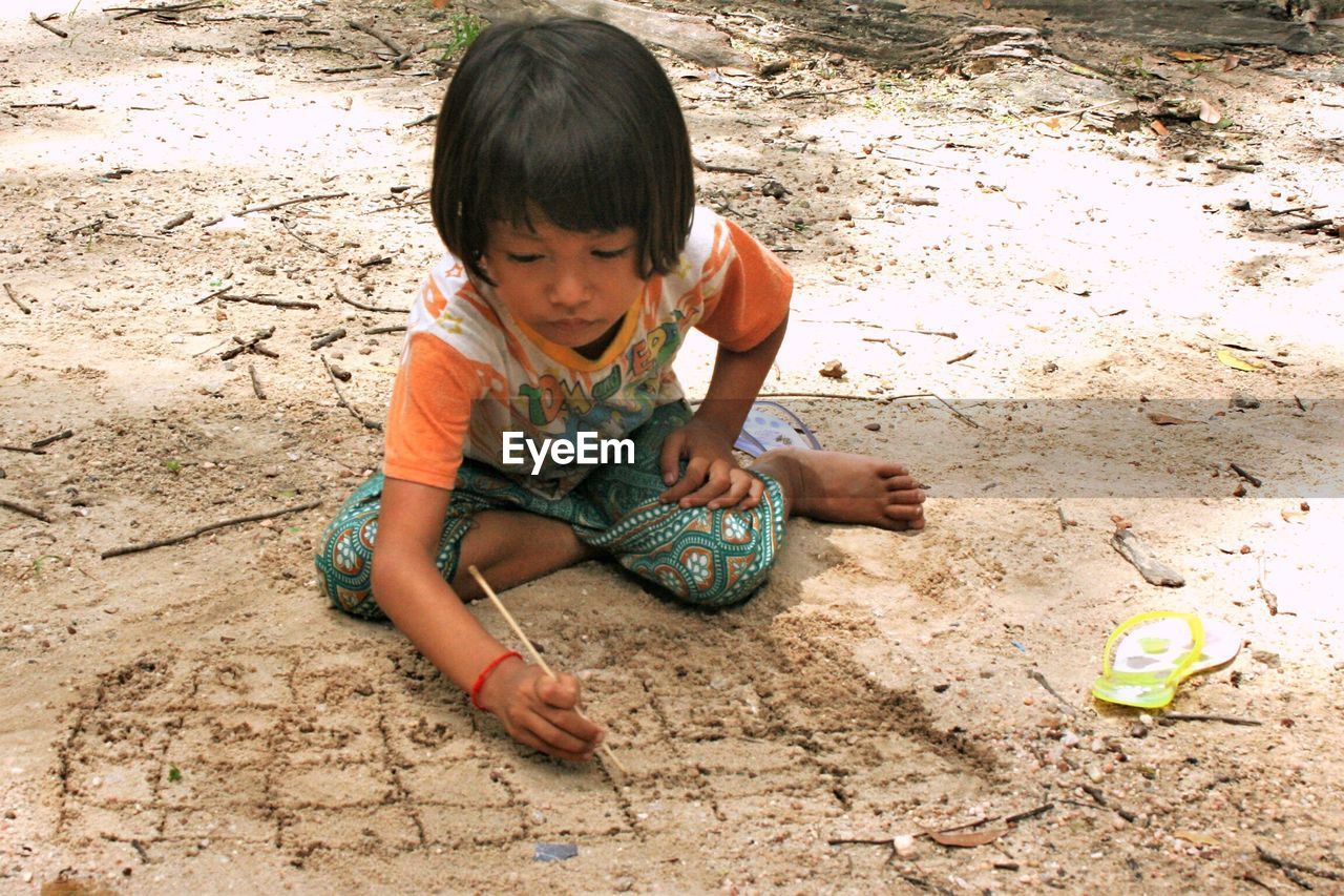 BOY PLAYING ON BEACH