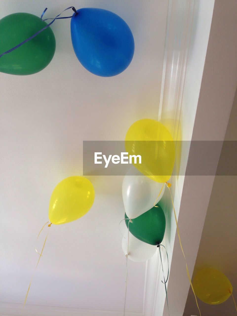 Low angle view of colorful balloons against ceiling