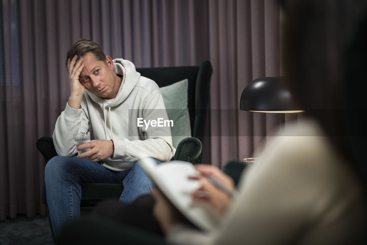 Man sitting in armchair at therapy session