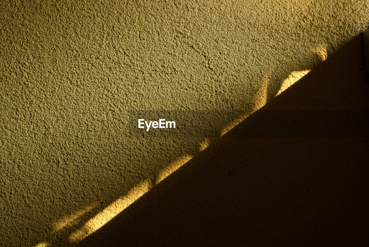HIGH ANGLE VIEW OF SHADOW ON WALL