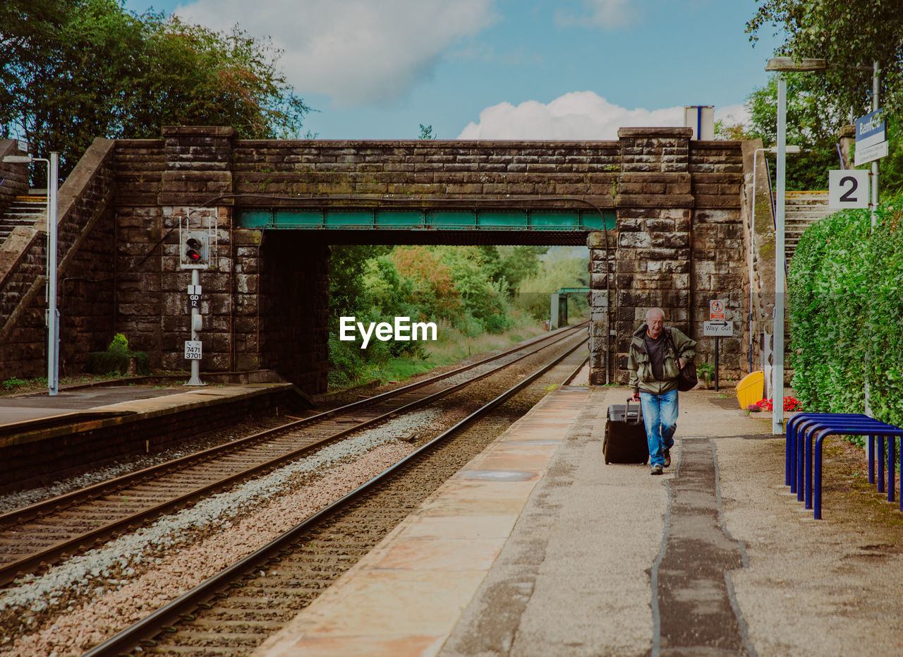 RAILROAD STATION PLATFORM AGAINST SKY