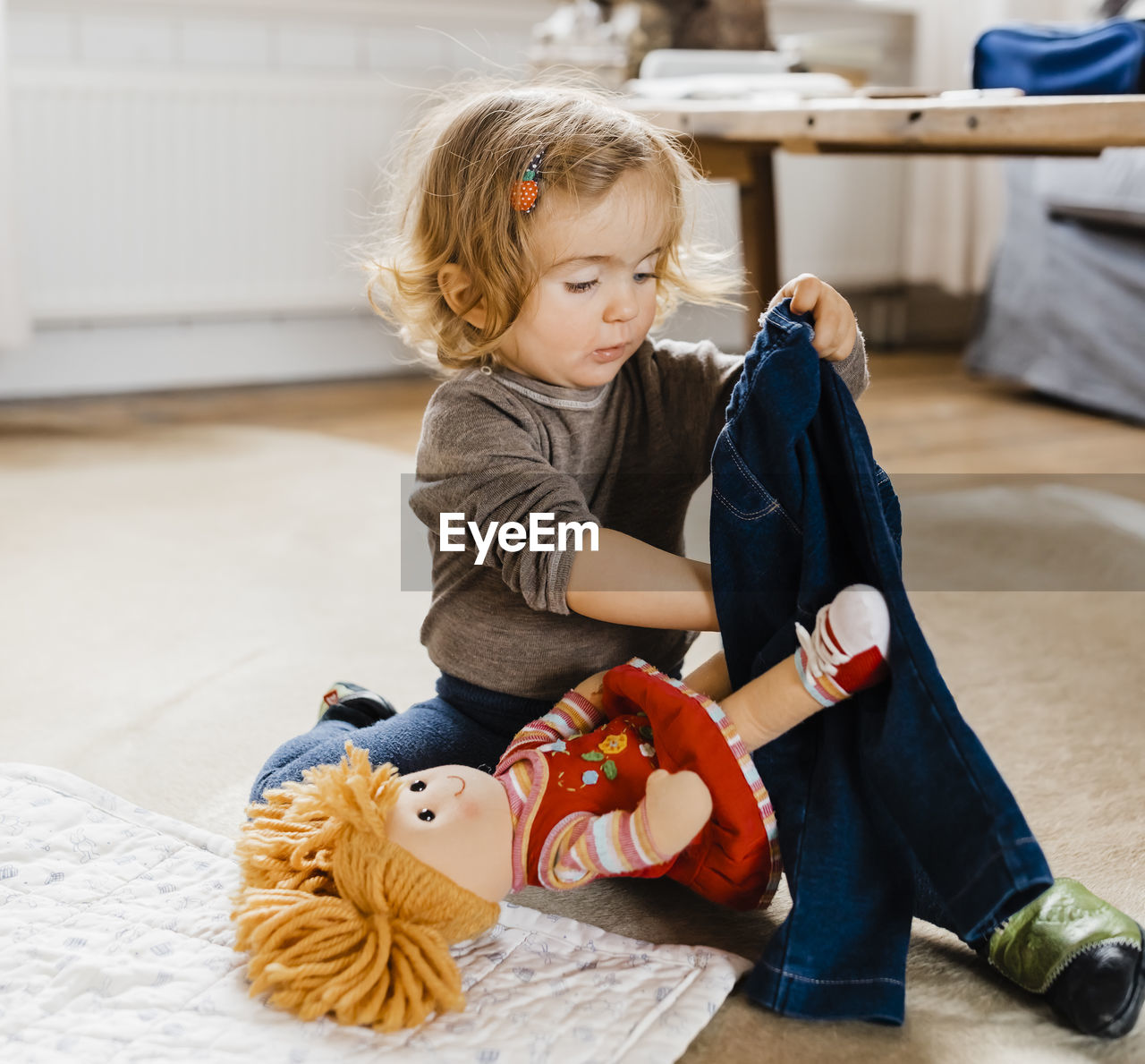 Cute girl playing with toys at home