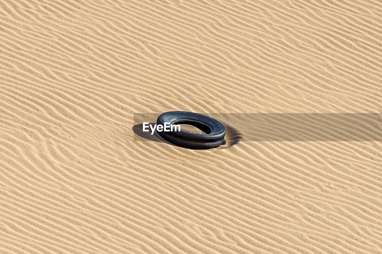 FULL FRAME SHOT OF SAND WITH TEXT ON LAND