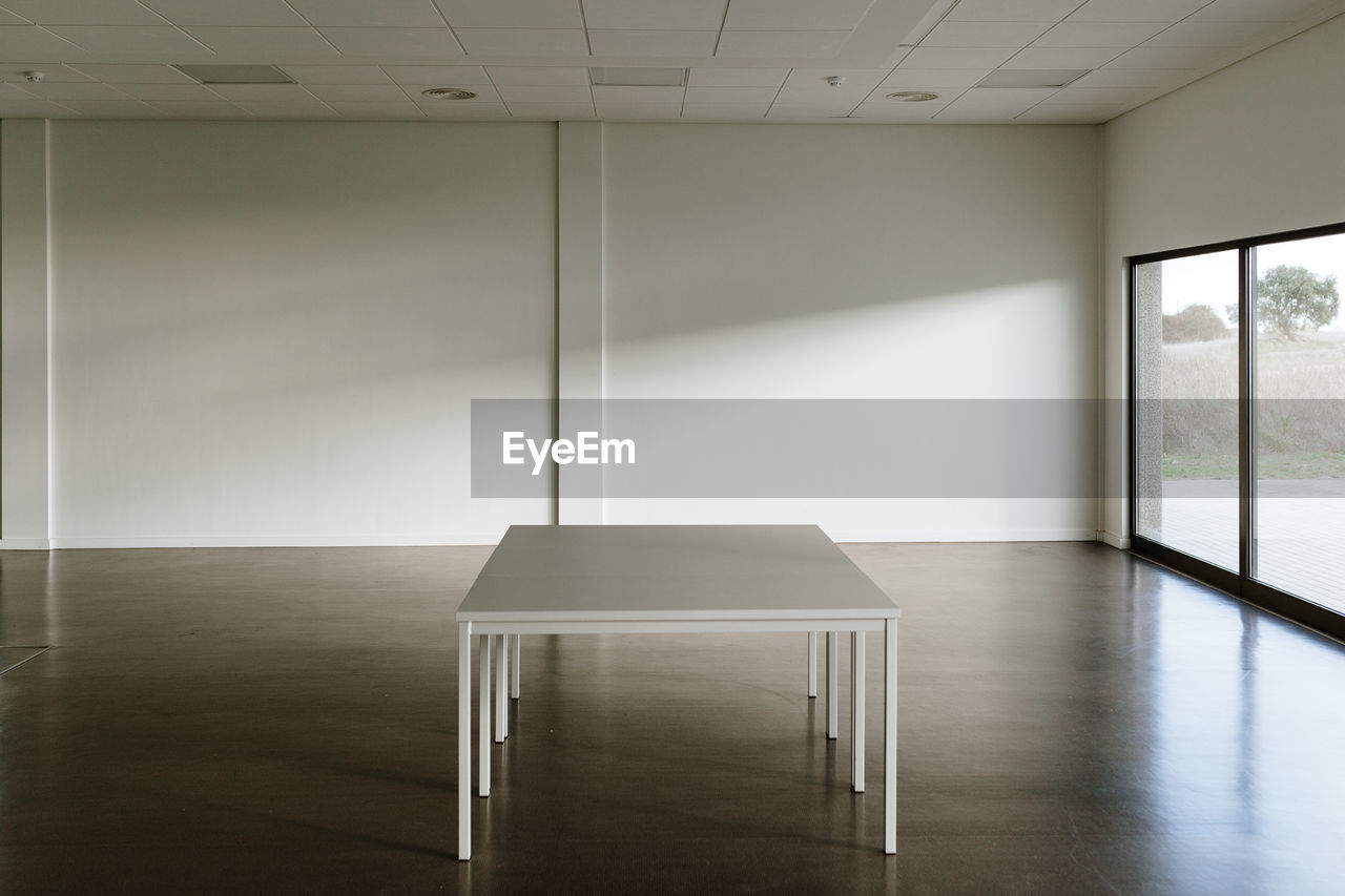 Empty chairs and table in building