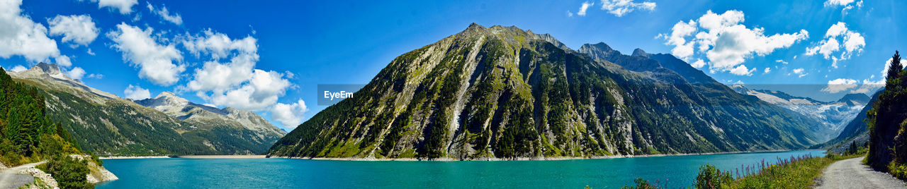 Panoramic view of lake amidst mountains against sky