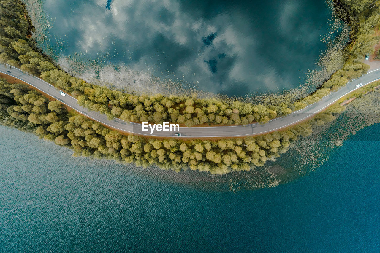 Aerial view of road and trees by sea