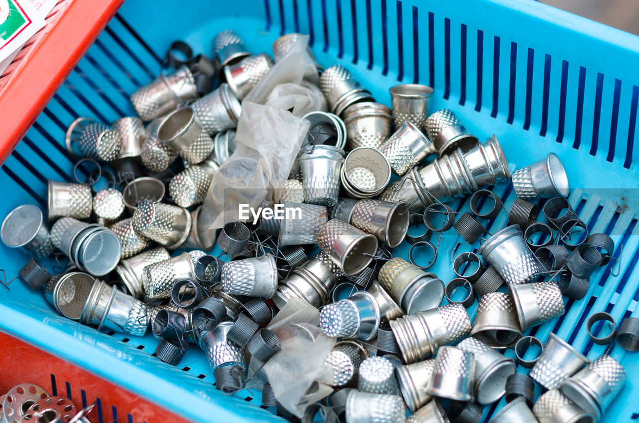 HIGH ANGLE VIEW OF GARBAGE CAN ON METAL