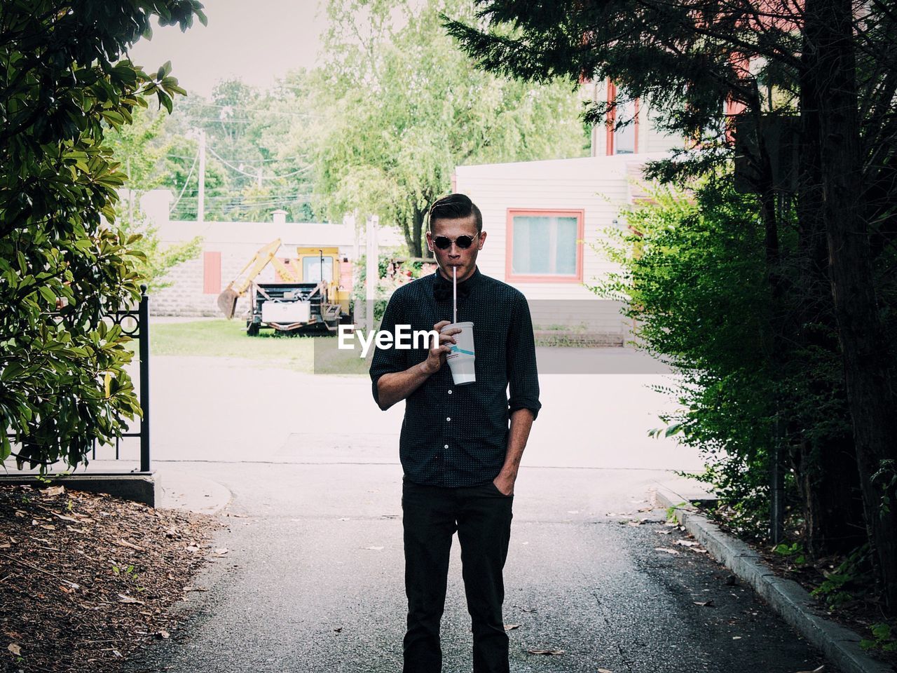 Portrait of handsome man holding on street