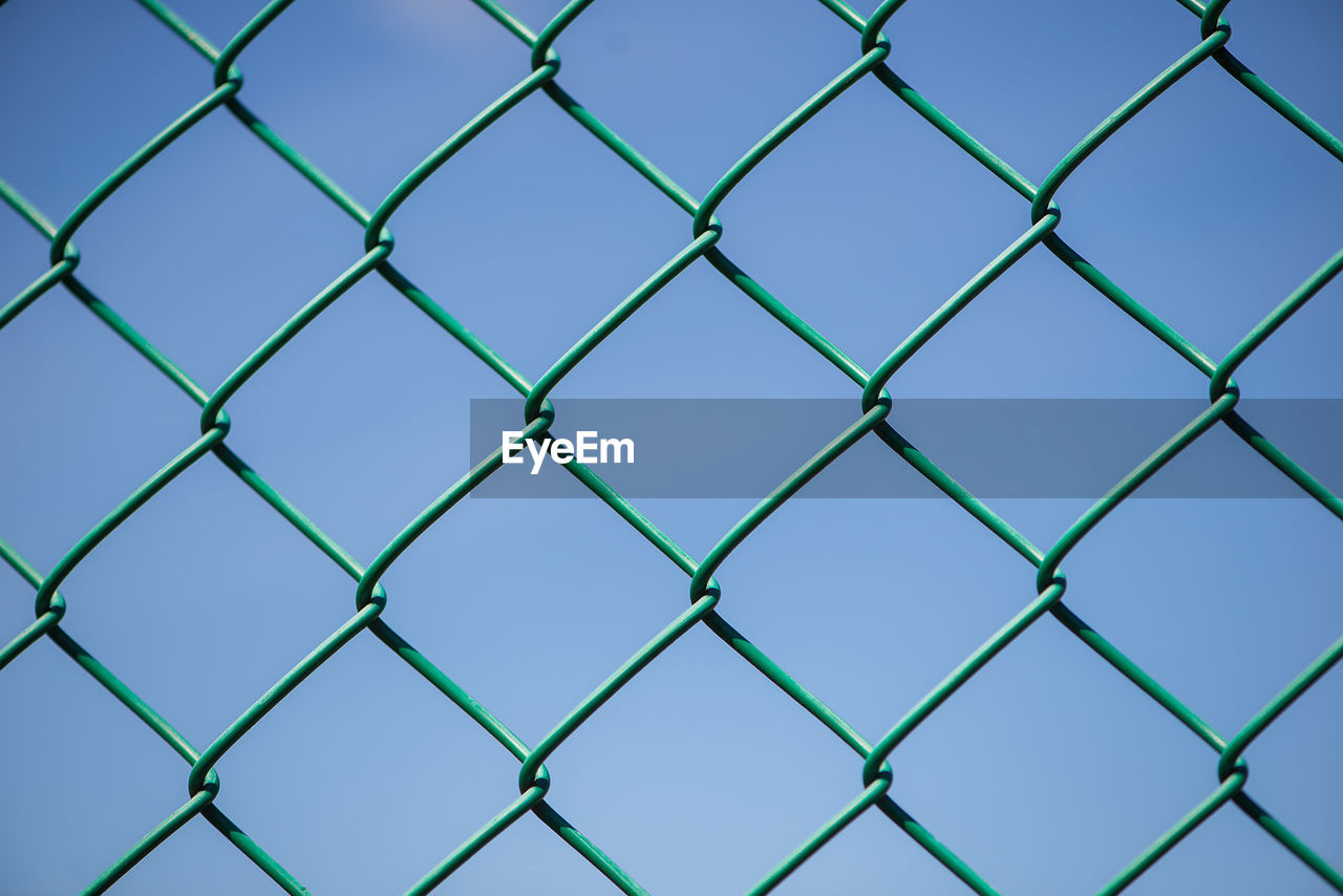 Full frame shot of chainlink fence against sky