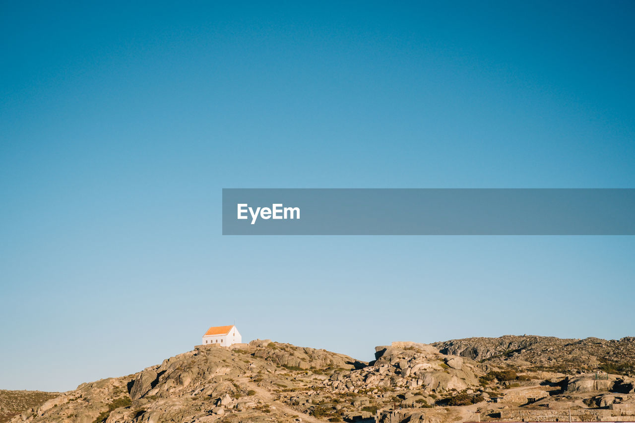 Low angle view of mountain against clear blue sky